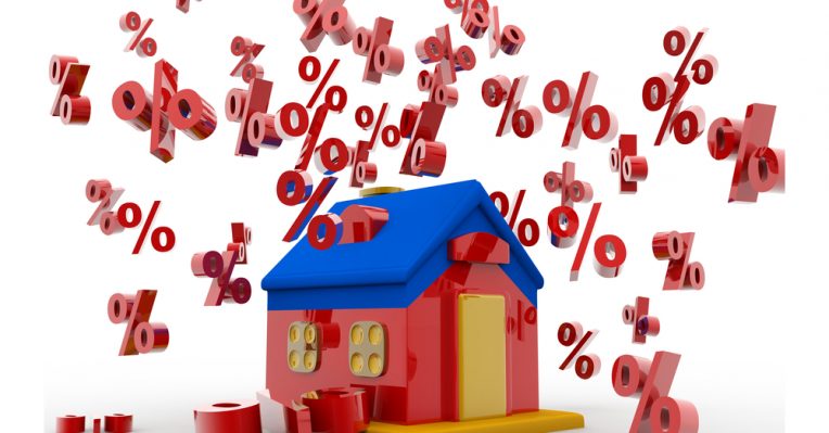 Percentage symbols tumble around a house to denote a story about mortgage rates
