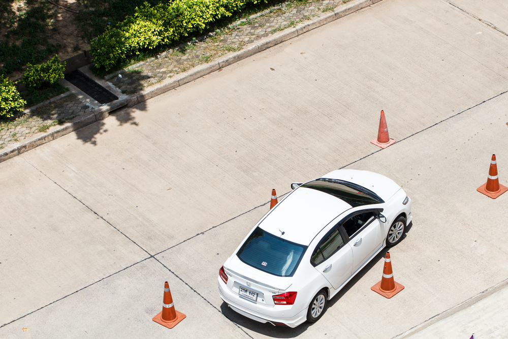 car driving around cones