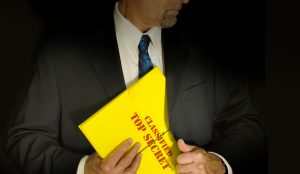 man in suit holding secret file