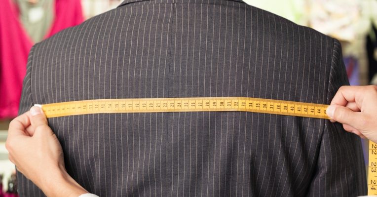 man getting measured for a suit