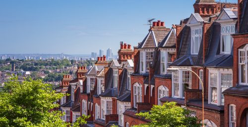 A row of terraced houses overlooks a view of London