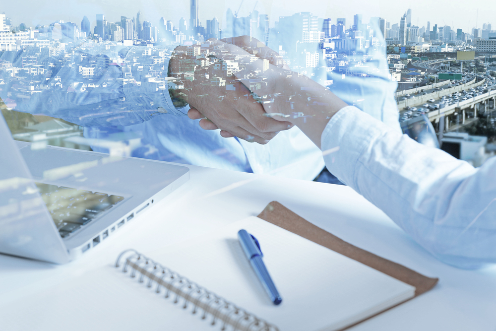 handshake with city scene in the background