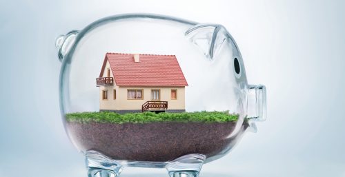 an image of a house inside a glass piggy bank to denote a story about the £5,000 deposit