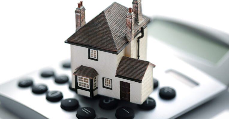 an image of a house on a calculator to denote mortgage demand