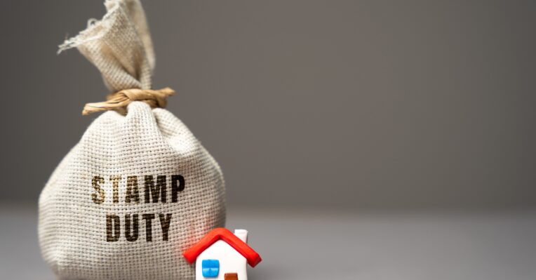 an image of a house and a sack reading 'stamp duty' to denote a story about a potential stamp duty cut