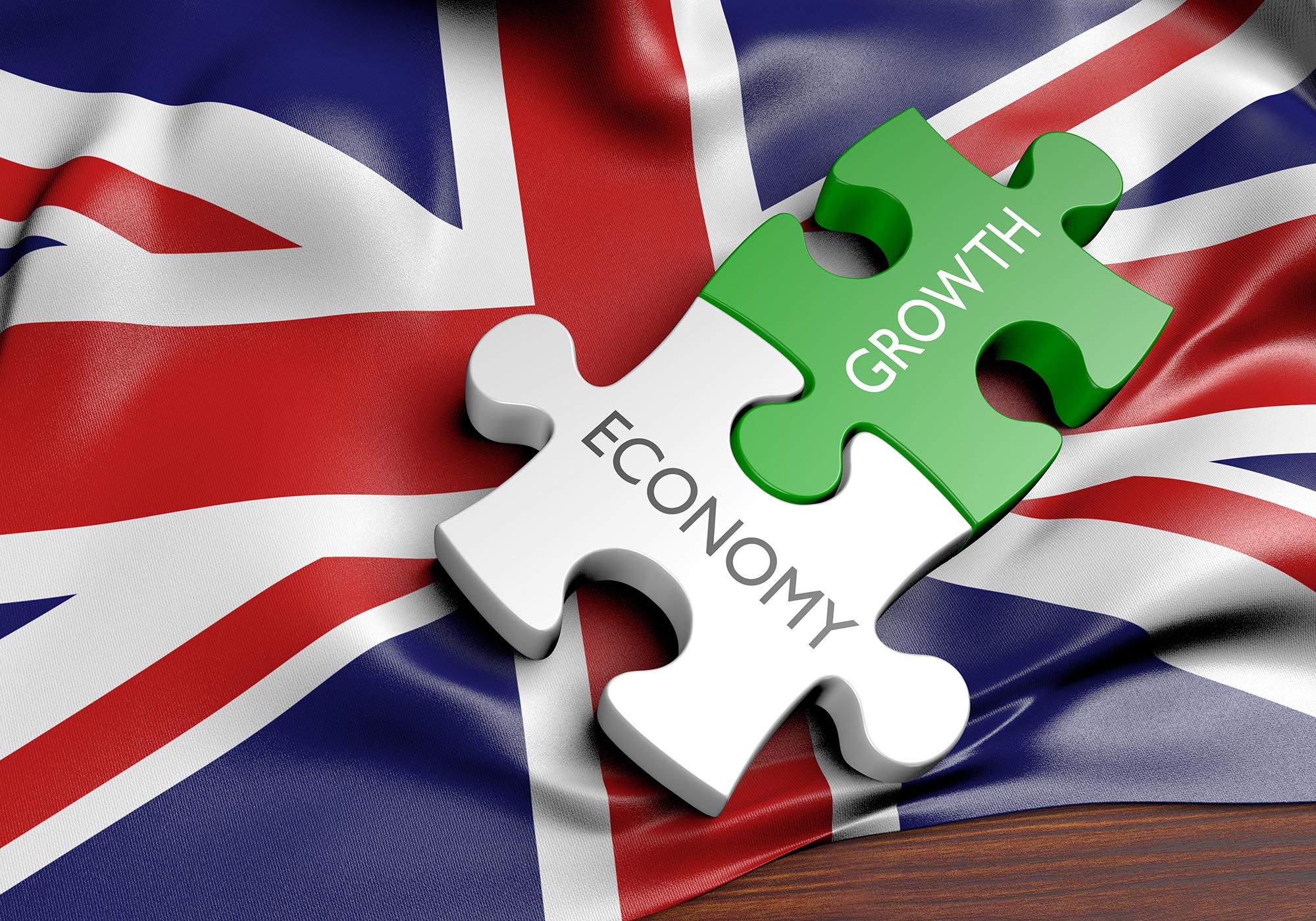 A photo of the UK flag with jigsaw pieces linking economy and growth to denote a story about the uk's recession