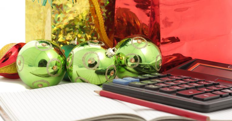 calculator and note pad with Christmas baubles to denote the mortgage year in 12 days