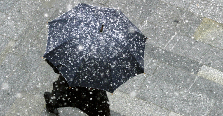 lady walking through snow with umbrella