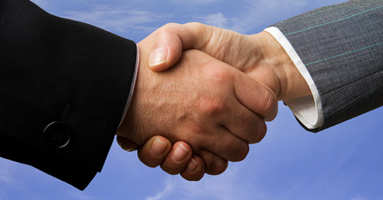 shaking hands to denote a story about downing property finance